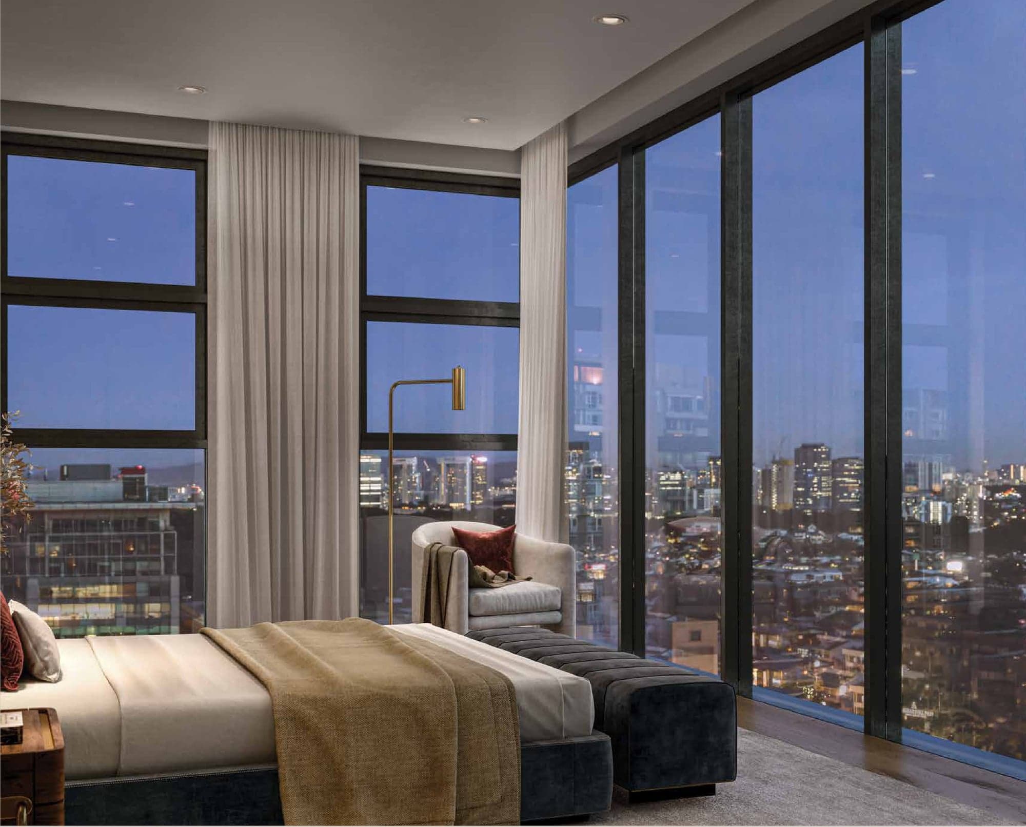 A bedroom at dusk with floor-to-ceiling glazing over the Bangsar rooftops