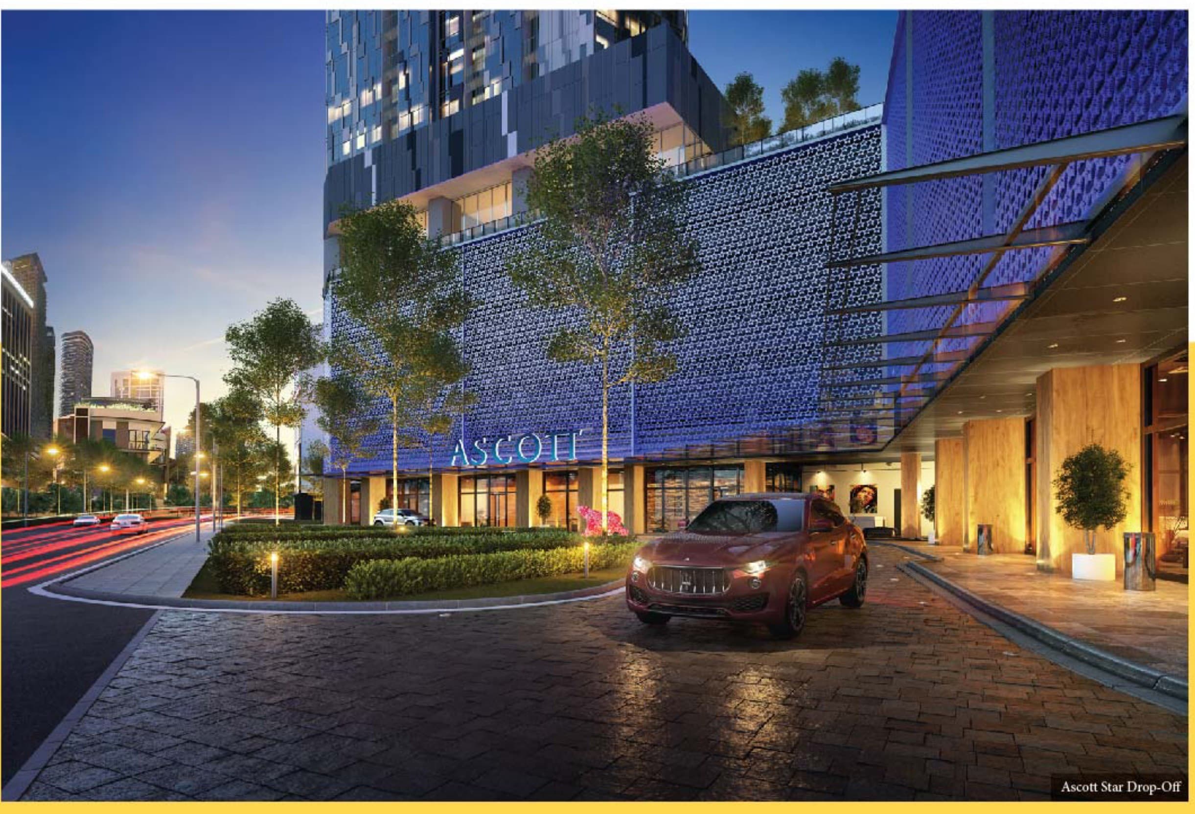 The Ascott Star drop-off — the tower's patterned podium screen lit blue over the porte-cochère on Jalan Yap Kwan Seng