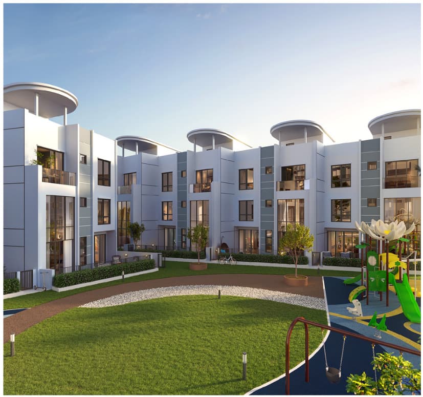 The seven town villas facing their own lawn and the children's playground, each three storeys with a private garden