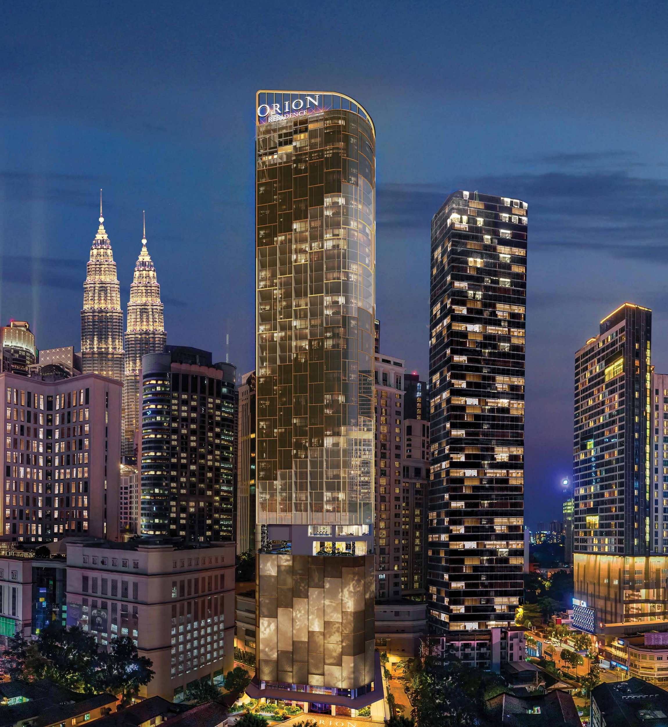 Orion Residence Bukit Bintang — the 46-storey tower lit at dusk with its illuminated Orion crown, the Petronas Twin Towers behind it and the Bukit Bintang skyline below