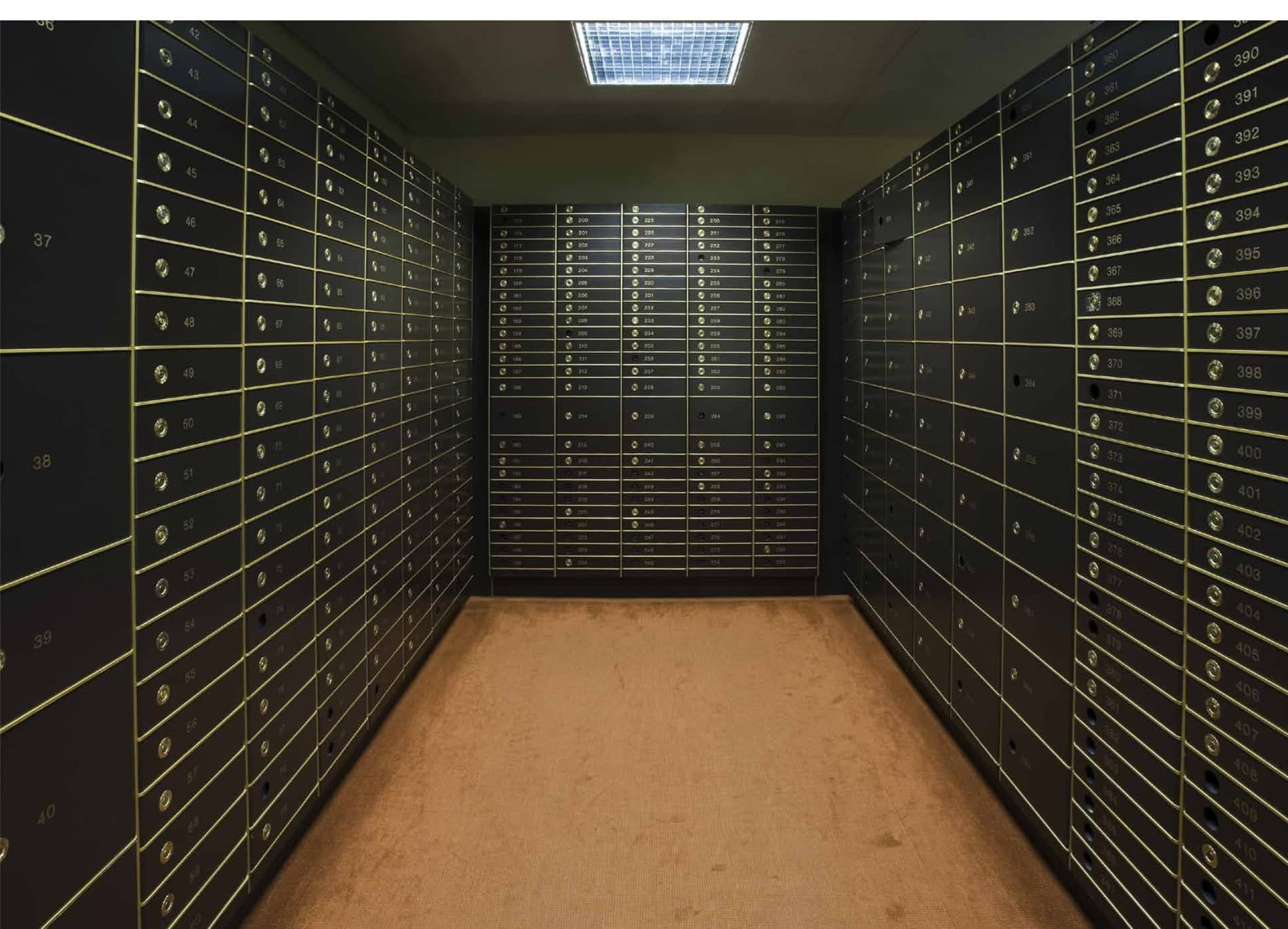 Orion Residence private vault room — a corridor of numbered high-security safe deposit boxes on both walls