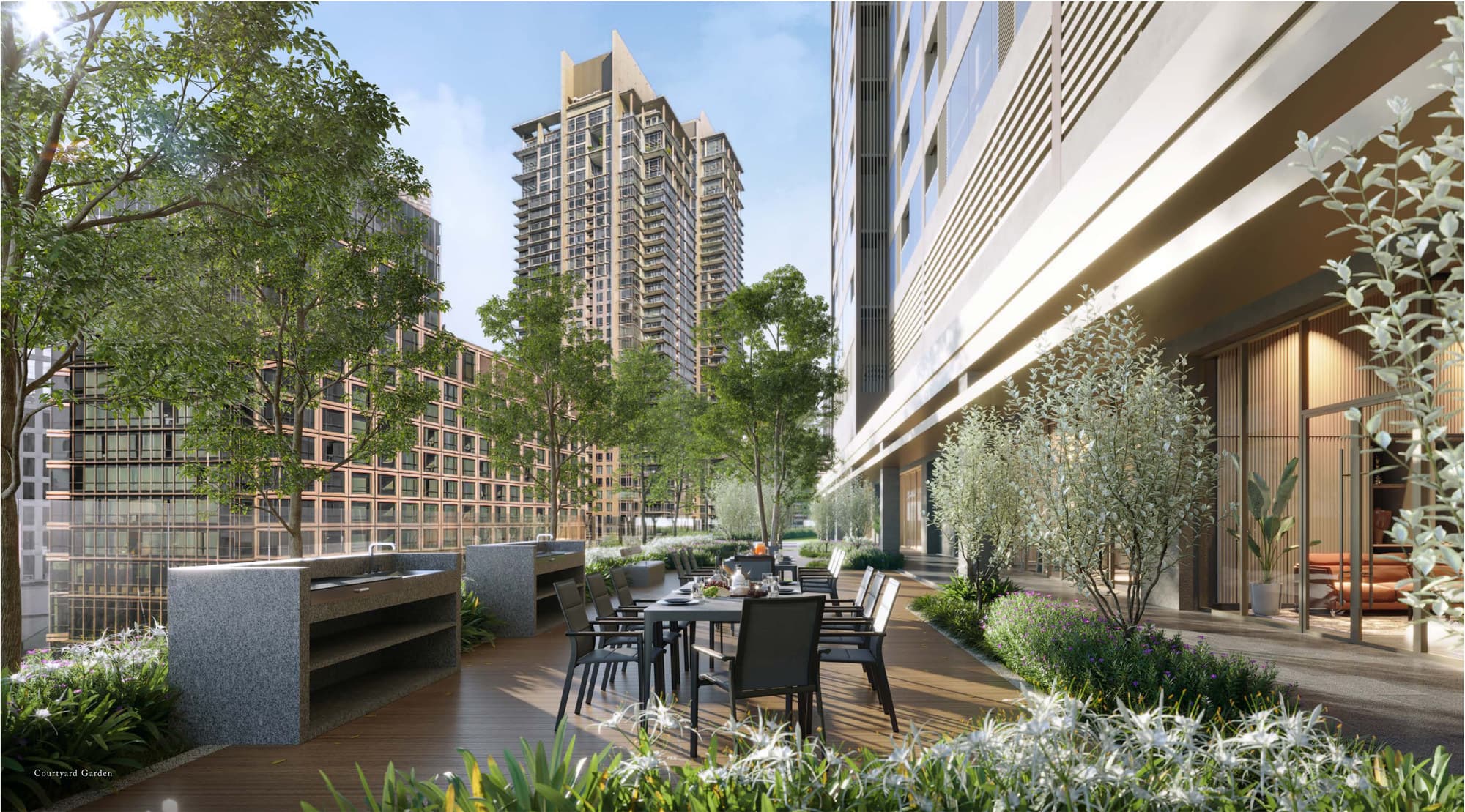 The Courtyard Garden at Level 12 — an outdoor kitchen and long dining table set into a landscaped deck between the two blocks, sheltered by the tower above