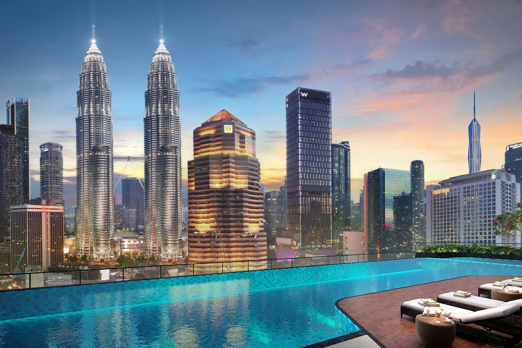 Aqua Terrace — the Level 8 pool deck at dusk, the water running out towards the Petronas Twin Towers and the W Kuala Lumpur across the KLCC skyline
